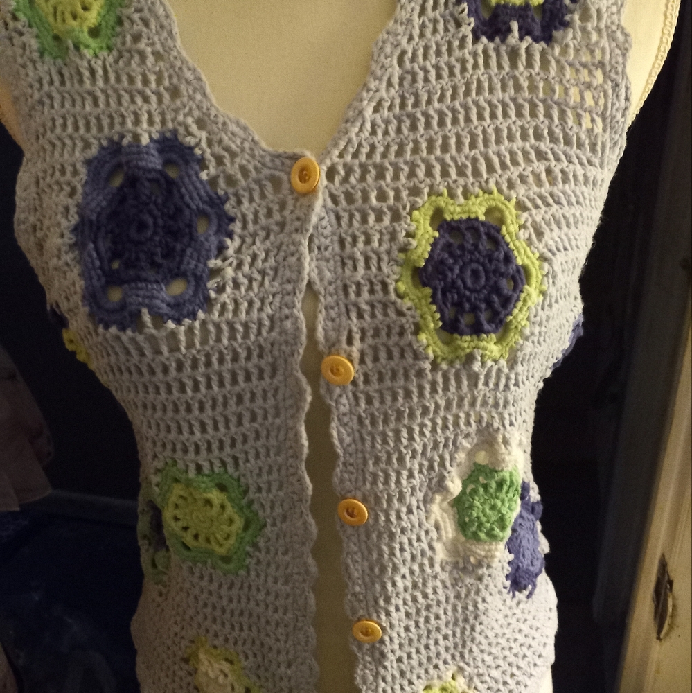 not new,never worn baby blue crochet vest with floral accents size medium.